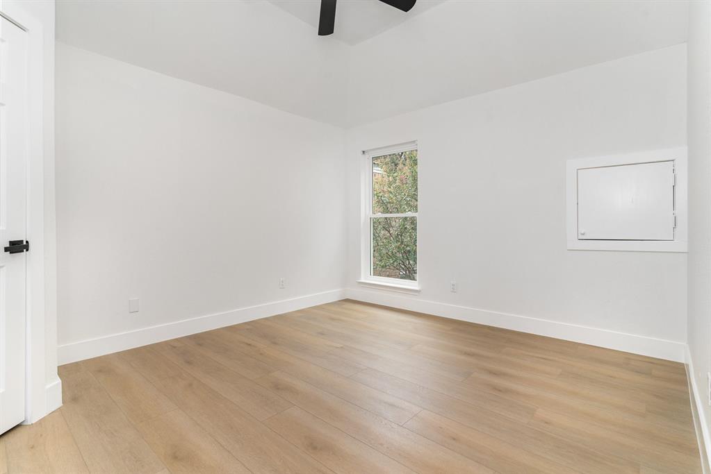 Spare room with light wood-type flooring and ceiling fan