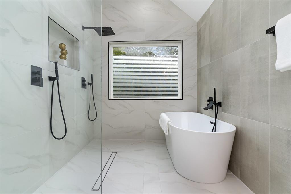 Bathroom with plus walk in shower and tile walls