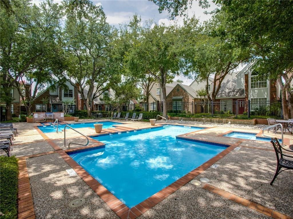 View of swimming pool featuring a hot tub and a patio area