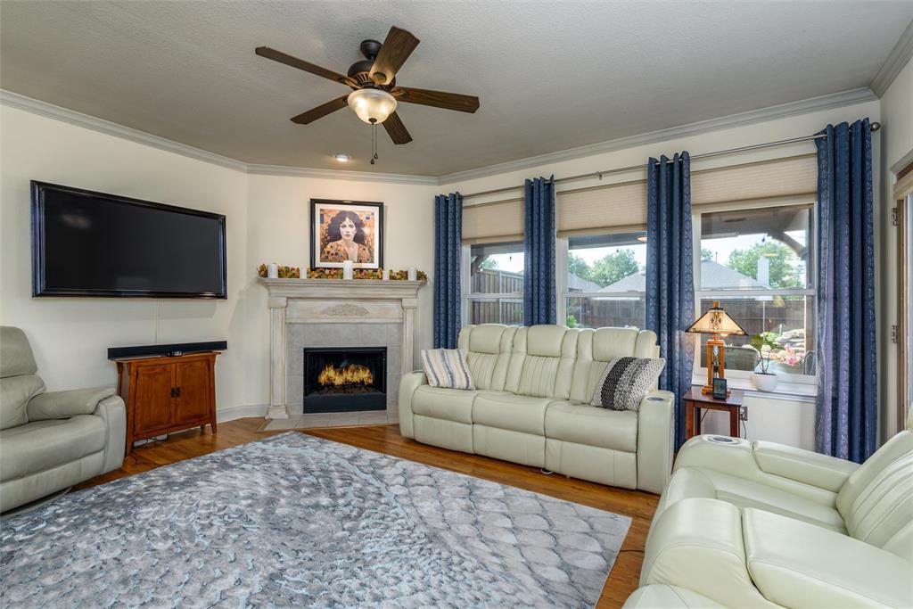 The living area has a fireplace and large windows for plenty of natural light.