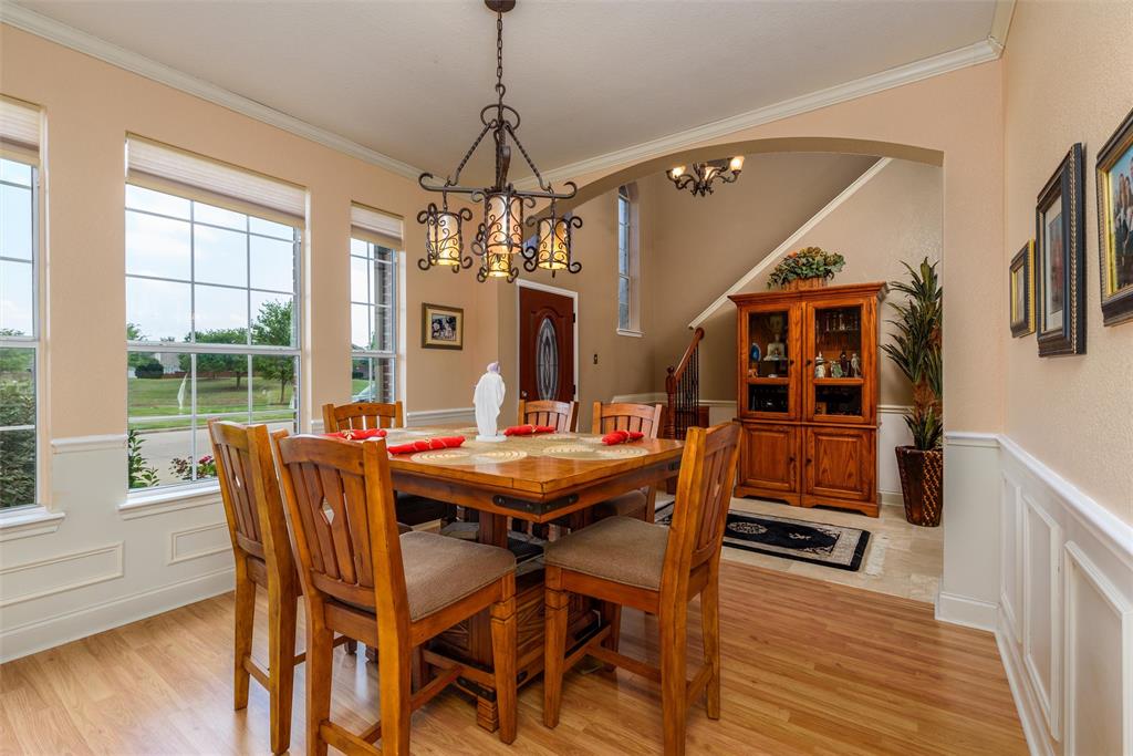 Dining area with ornamental molding sits off the front entry.