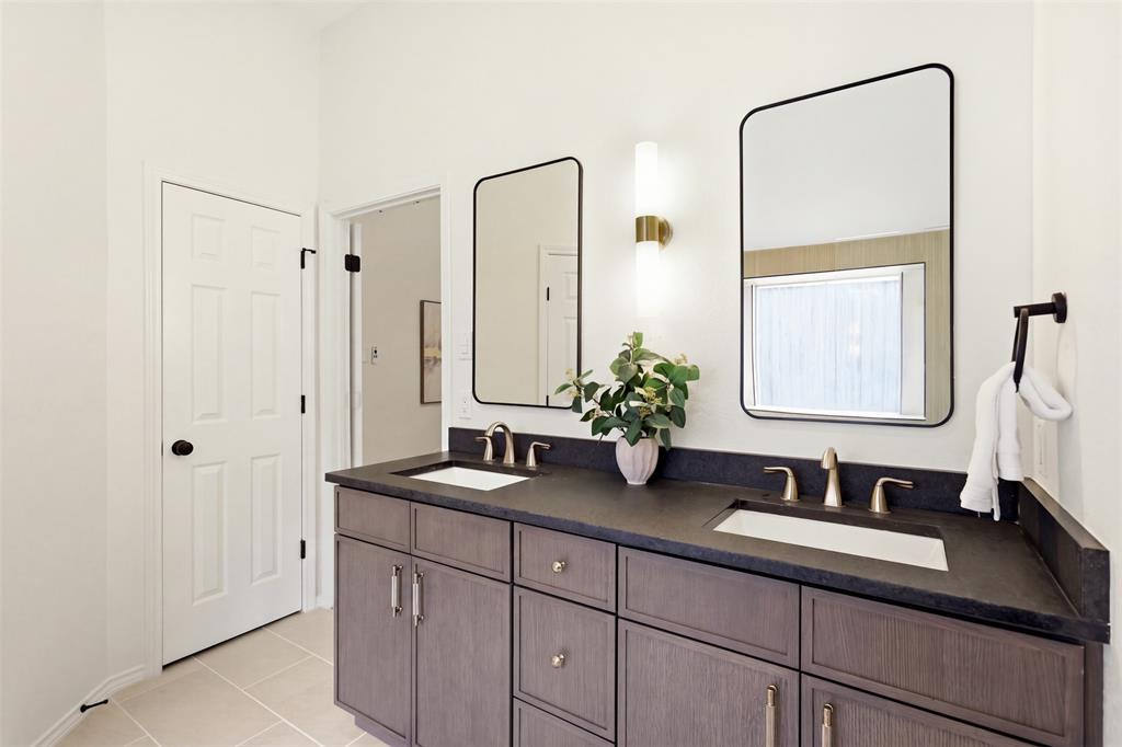 Double vanity with dark wood-finish cabinetry and dual undermount sinks