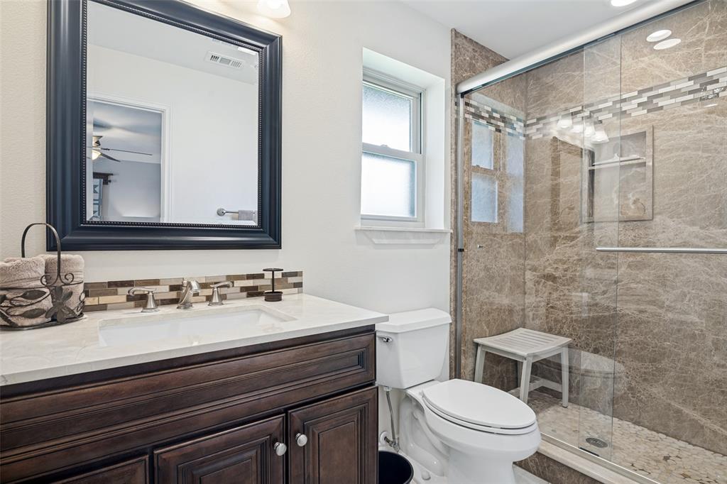 Dark wood-finish vanity with a white countertop and rectangular sink