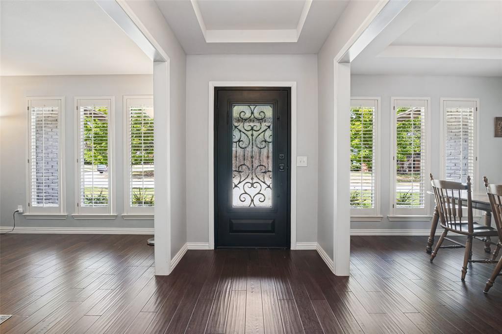 Entry featuring a dark-finish door with decorative ironwork