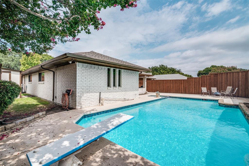 White brick exterior with a brown roof and gutters