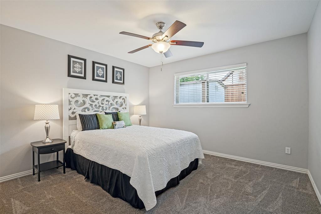 Carpeted flooring, window with blinds, ceiling fan with integrated lighting, and neutral wall paint