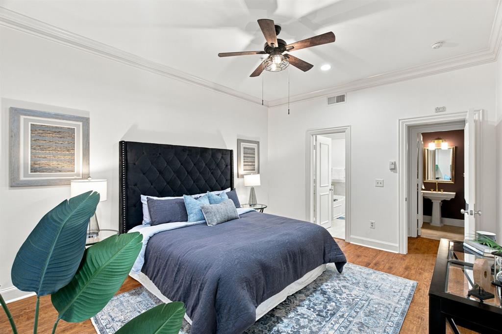 Hardwood-finish flooring, crown molding, and a ceiling fan with light fixture