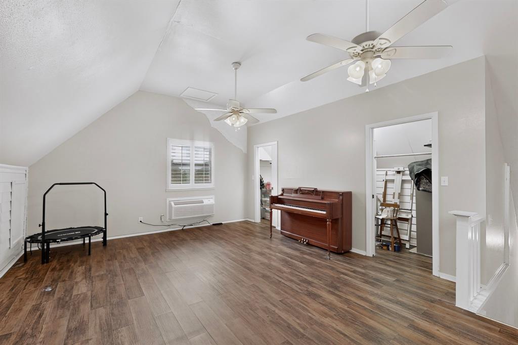 Wood-finish flooring throughout, complemented by sloped ceilings