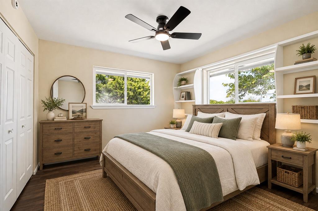 Wood-finish flooring, built-in shelving, dual pane windows, ceiling fan, and bi-fold closet doors