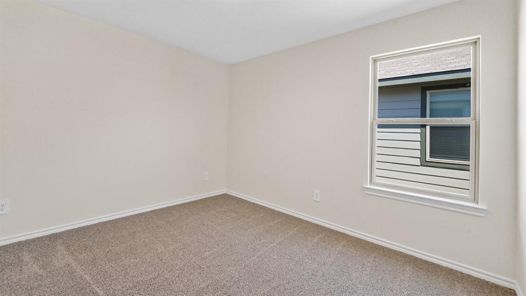 Neutral-toned walls complement the textured carpet flooring