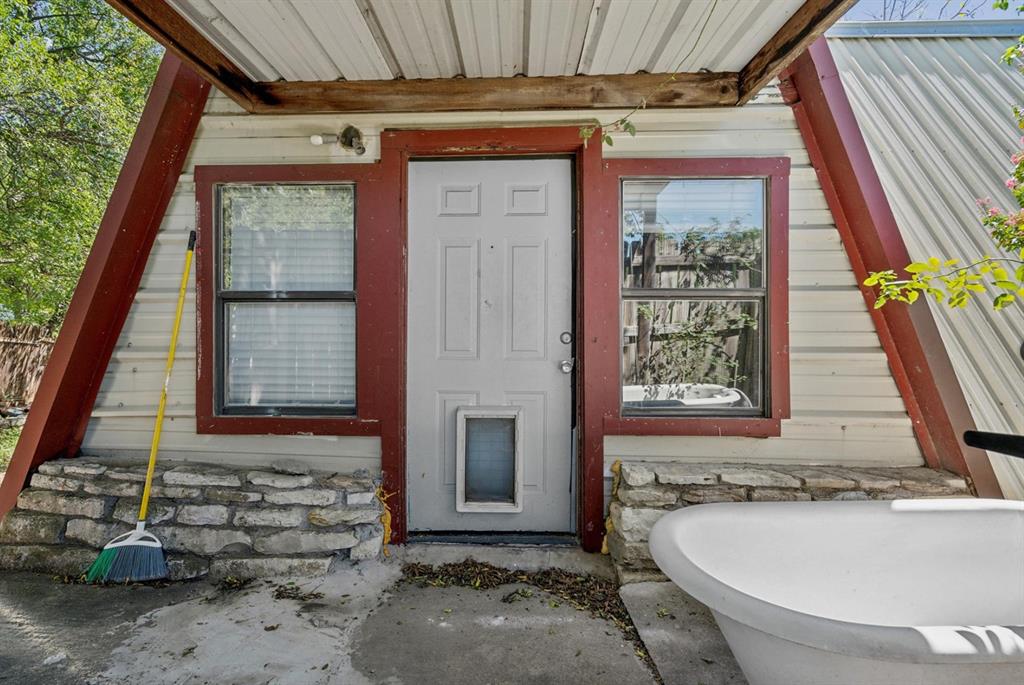 Entrance to property featuring metal roof