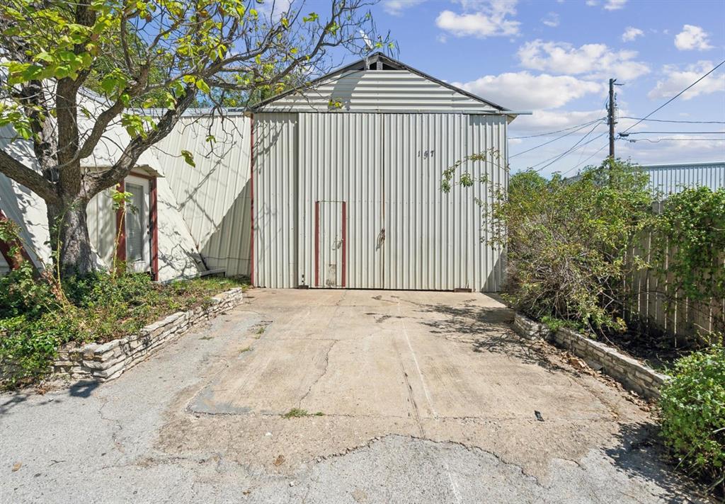 View of outdoor structure with fence and an outdoor structure