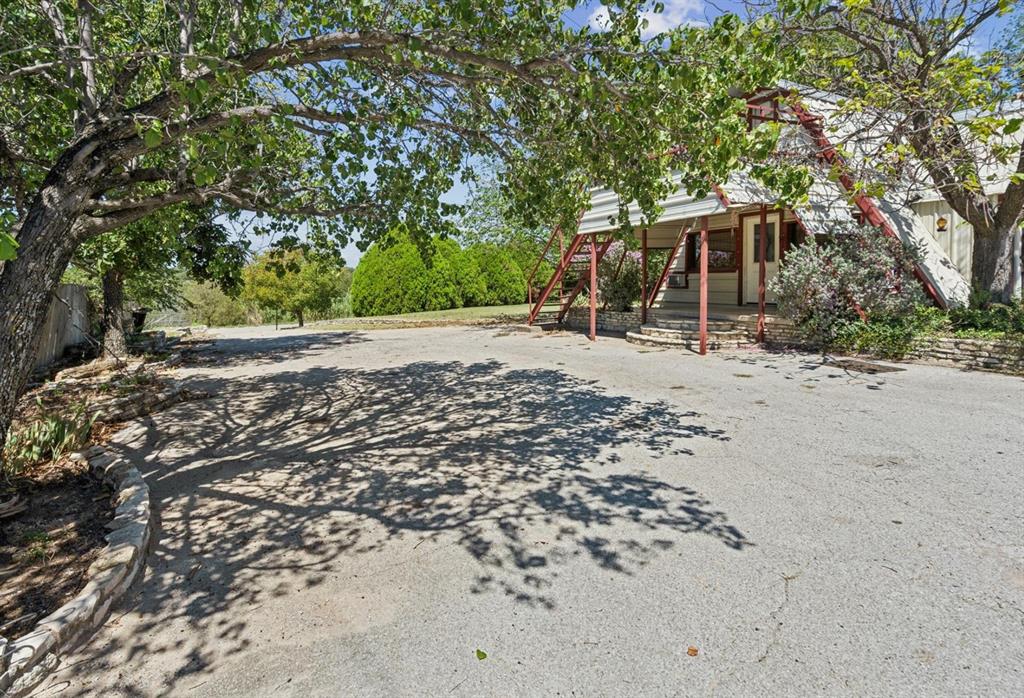View of yard with covered porch and stairway