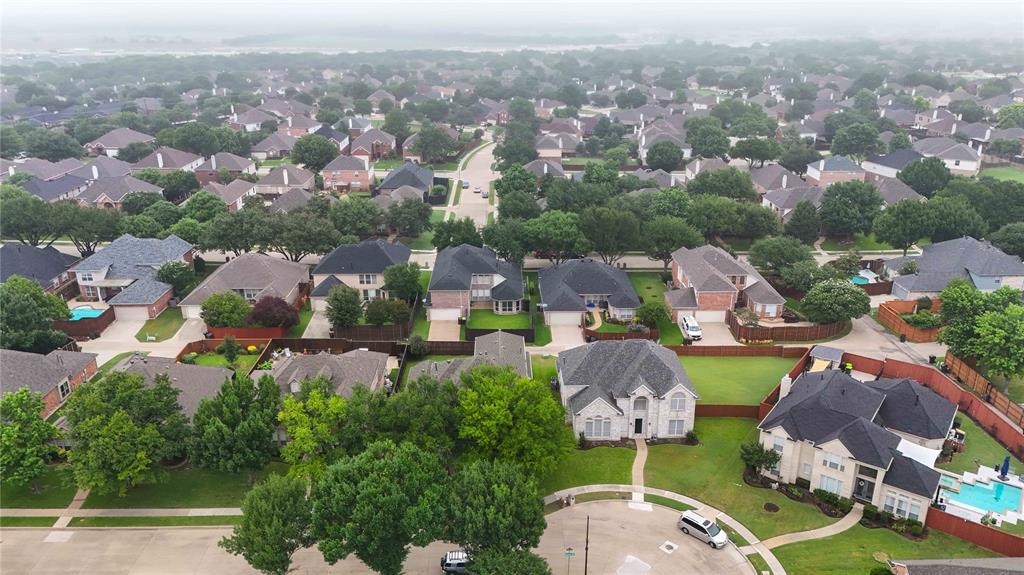 Expansive residential neighborhood with mature trees, established homes, and private swimming pools