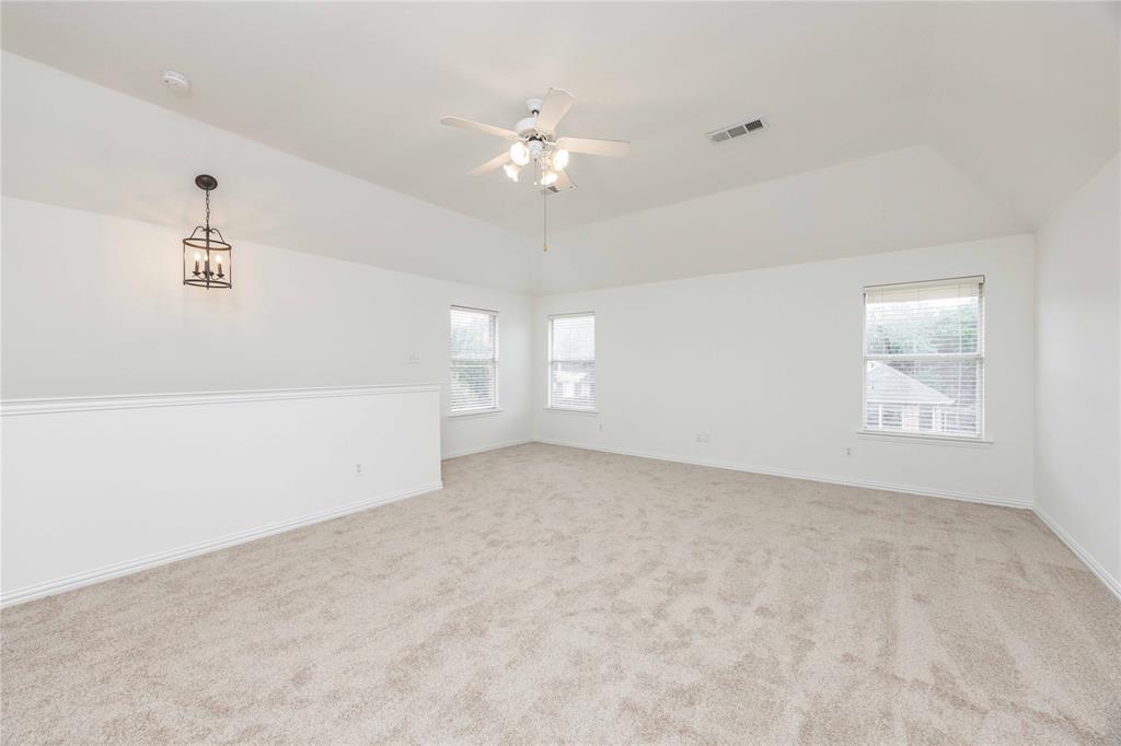 Vaulted ceiling with ceiling fan, recessed windows, and carpet flooring