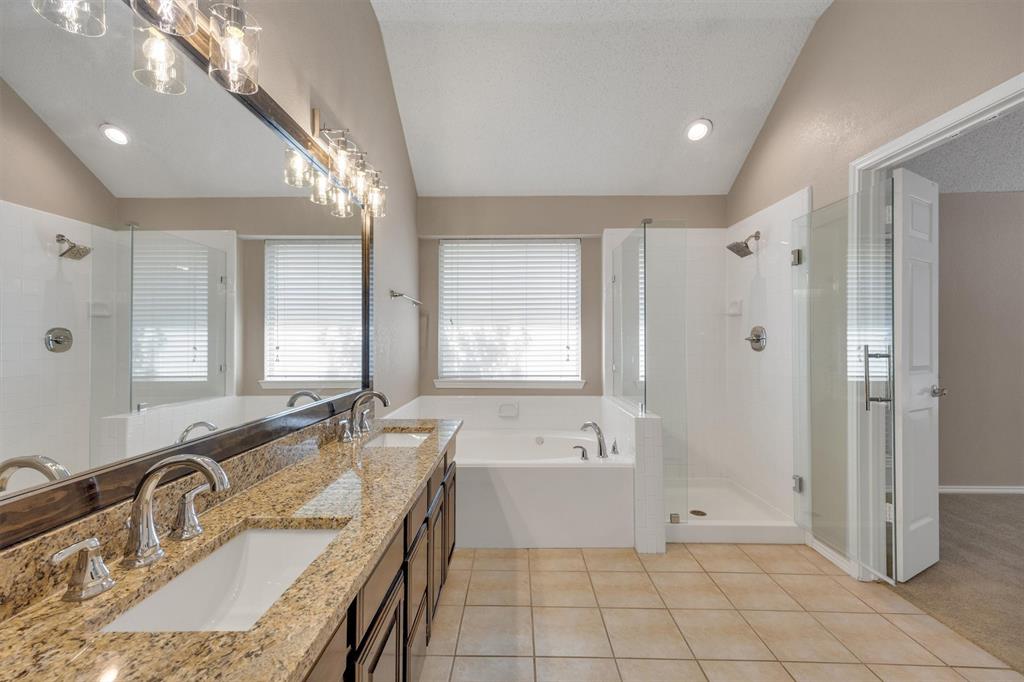 Large primary bathroom with separate tub and shower.