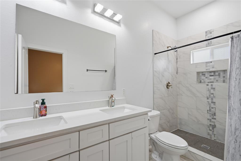 Contemporary bathroom featuring a double vanity and beautiful shower