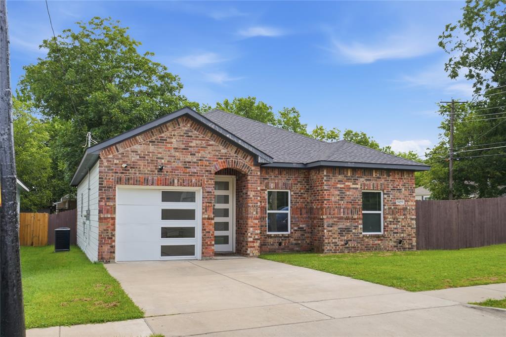Brick facade home featuring a single-car garage with frosted panel inserts and a covered entry