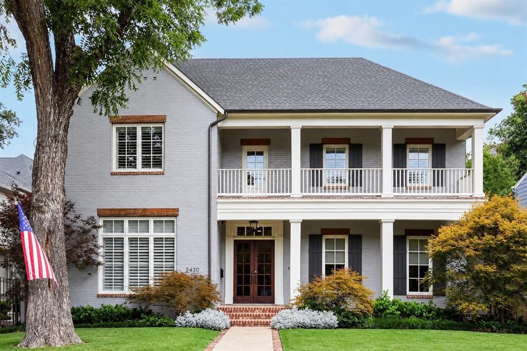 Light gray brick exterior with a dark shingle roof