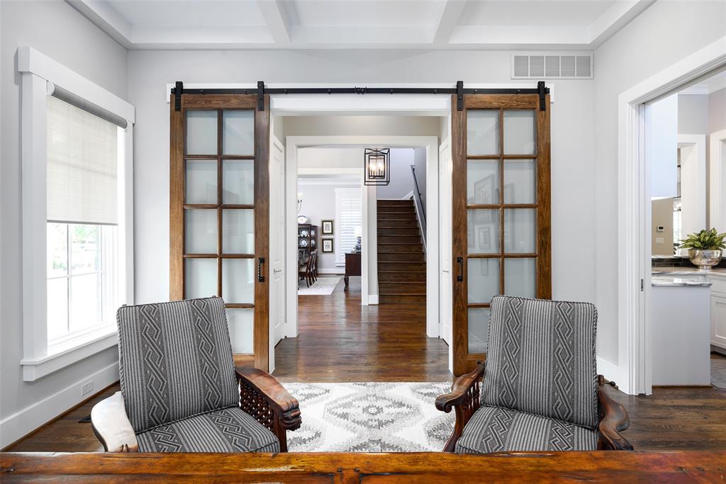 Solid wood flooring, coffered ceiling, transom window, and sliding barn doors with frosted glass panels Solid wood flooring, coffered ceiling, transom window, and sliding barn doors with frosted glass panels