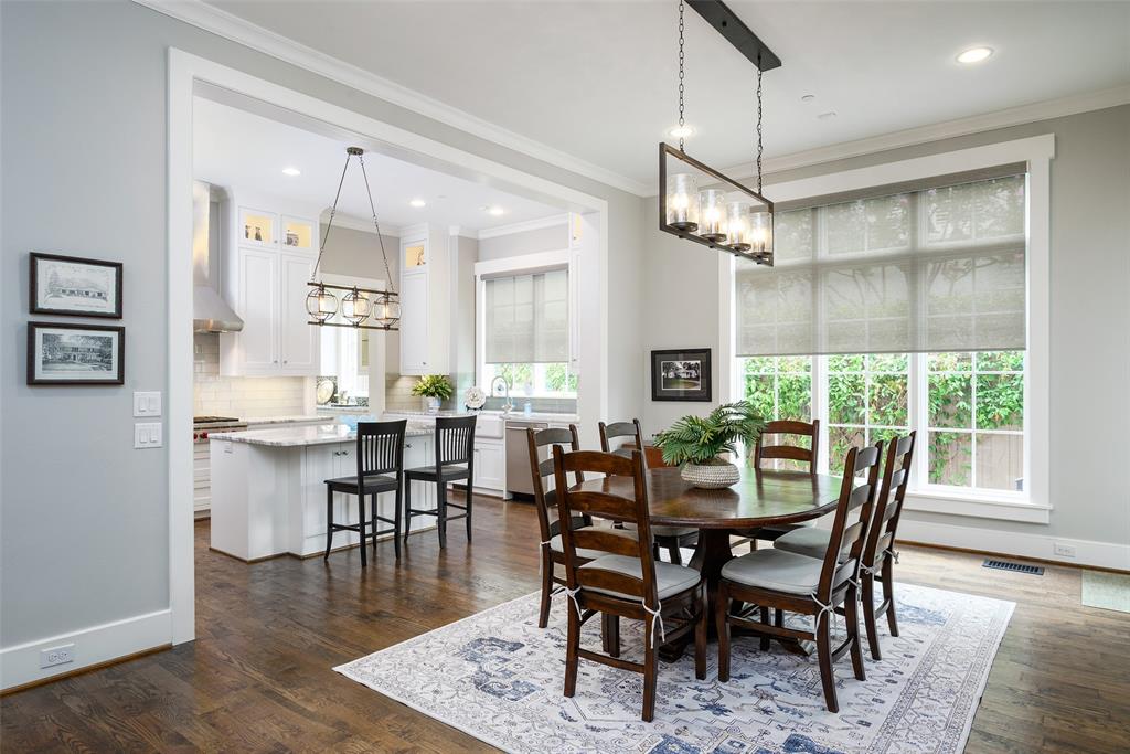Expansive dining area with hardwood flooring and large windows