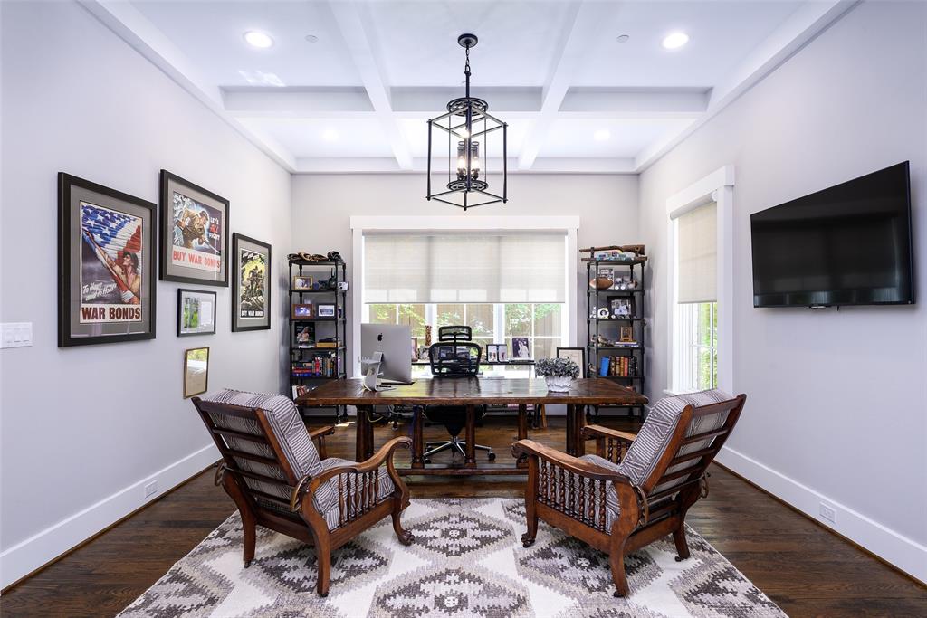 Coffered ceiling with recessed lighting and a central chandelier Coffered ceiling with recessed lighting and a central chandelier
