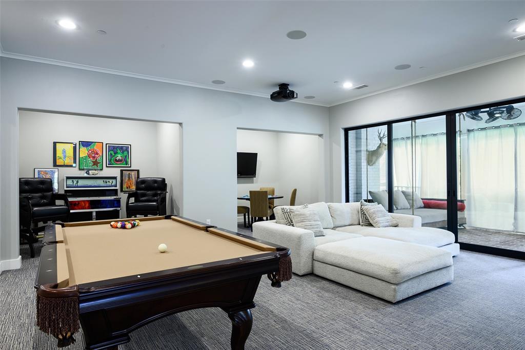 Recessed lighting, crown molding, built-in ceiling speakers, projector, and large sliding glass doors