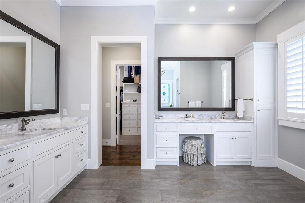 Dual vanity with white cabinetry, stone countertops, and undermount sinks