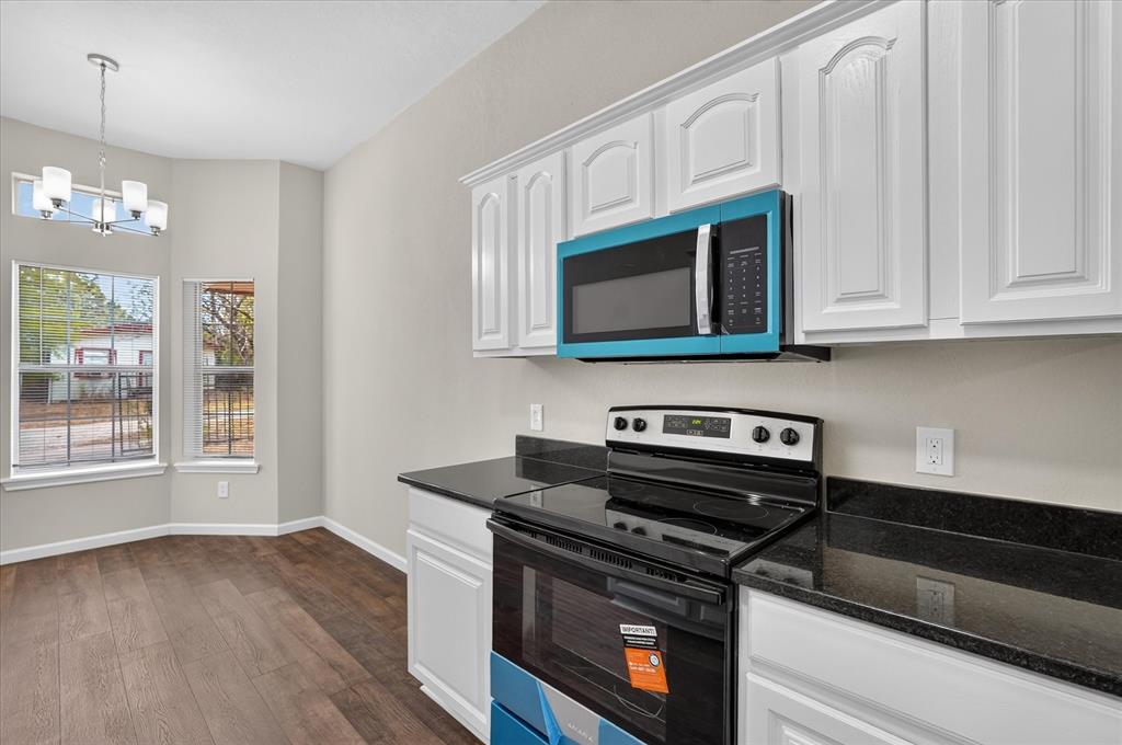 White cabinetry with black countertops