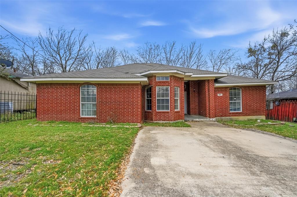 Brick exterior with a gabled roof and a concrete driveway
