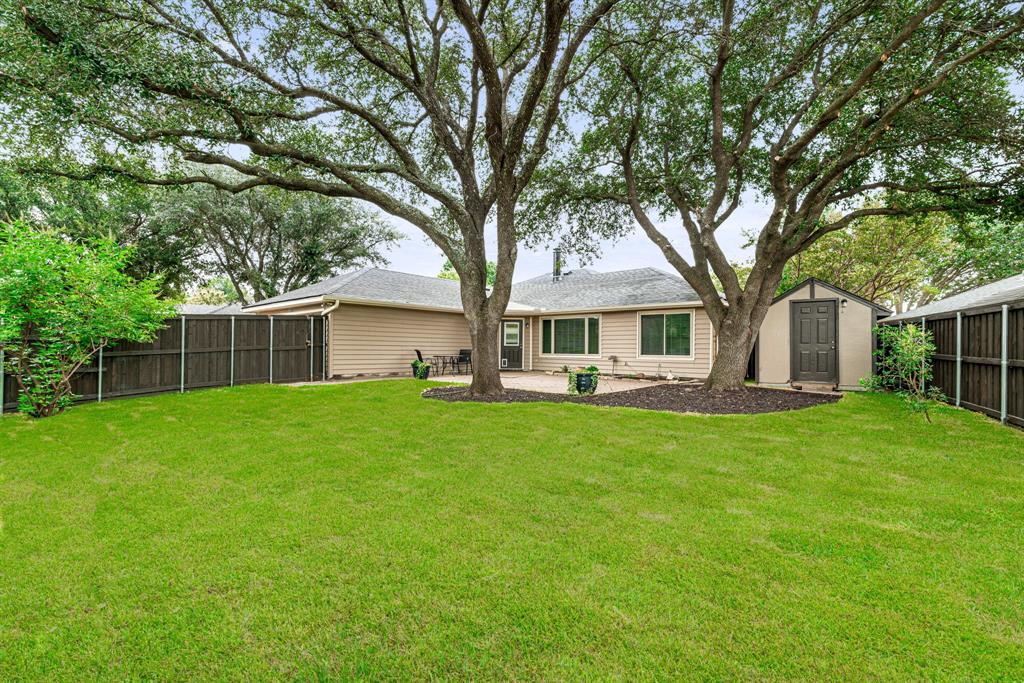 Backyard views - note the storage shed great for organizing yard equipment and outdoor items.