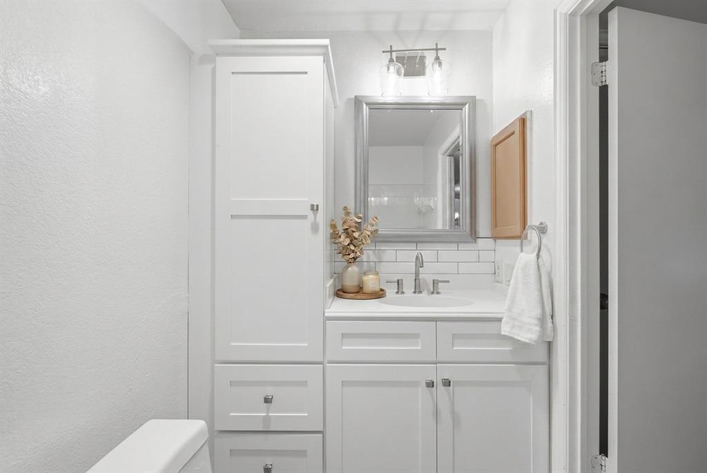 Full bathroom with updated cabinets, light fixture - servicing guests and secondary bedrooms.