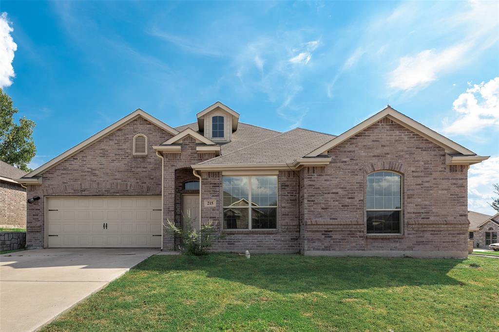 Brick exterior with multiple gables, arched windows, an integrated garage, and a dormer window Brick exterior with multiple gables, arched windows, an integrated garage, and a dormer window