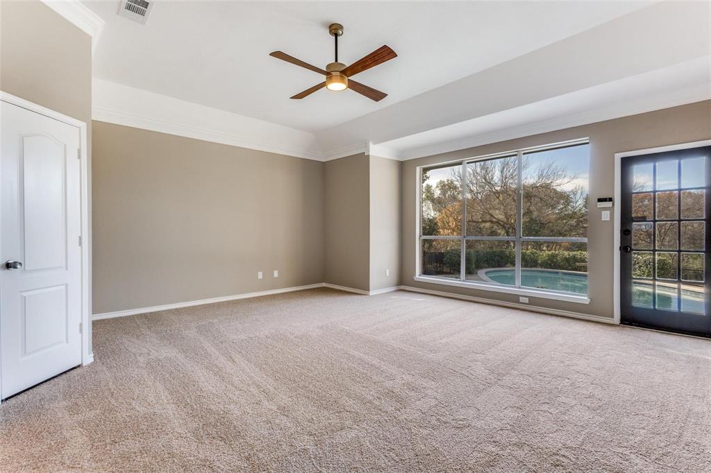 Spacious primary suite is overlooking the golf course and pool, with private door to backyard.