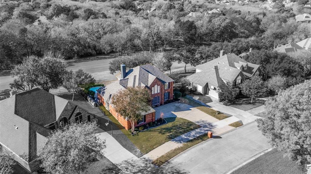 Brick exterior with multiple gables, an attached garage, and a private pool