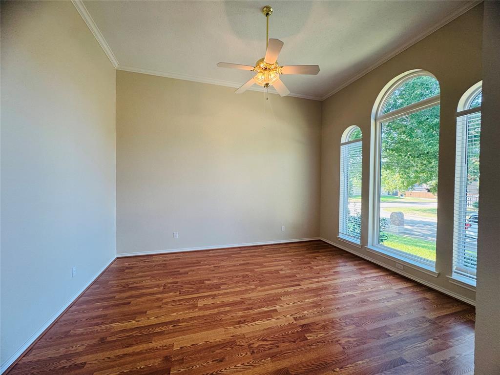 Vaulted ceiling with crown molding, wood-finish flooring, and multiple arched windows Vaulted ceiling with crown molding, wood-finish flooring, and multiple arched windows