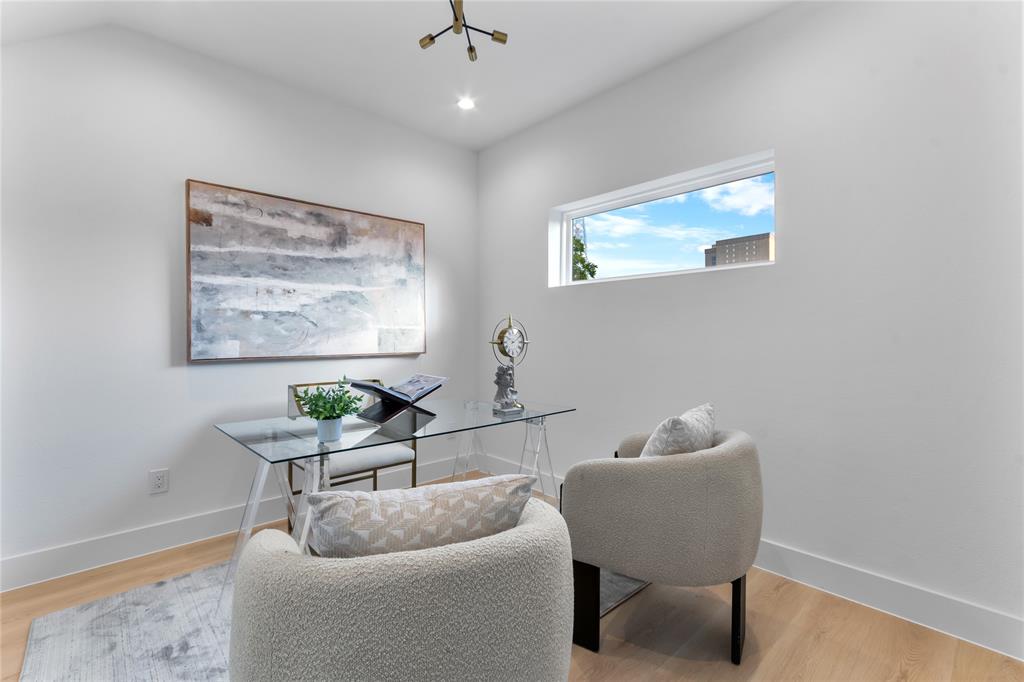 Dedicated room featuring light wood-finish flooring, a contemporary horizontal window, and a modern light fixture