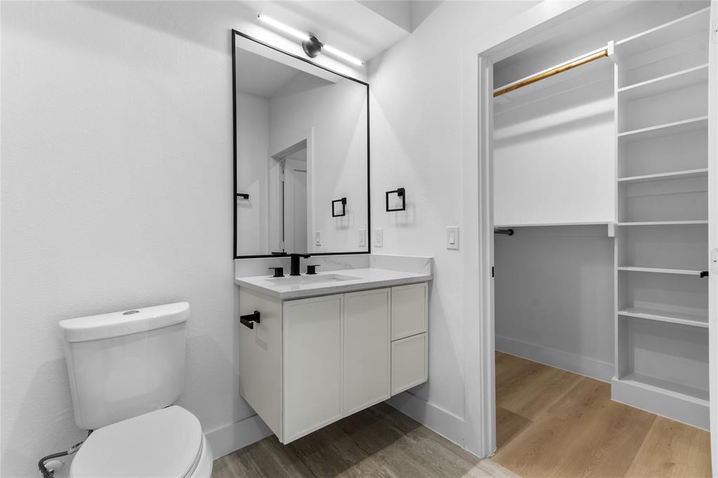 Bathroom featuring a floating vanity with a white countertop and matte black fixtures