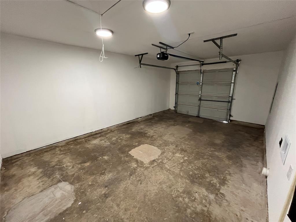 Garage space with a roll-up door and an automatic opener