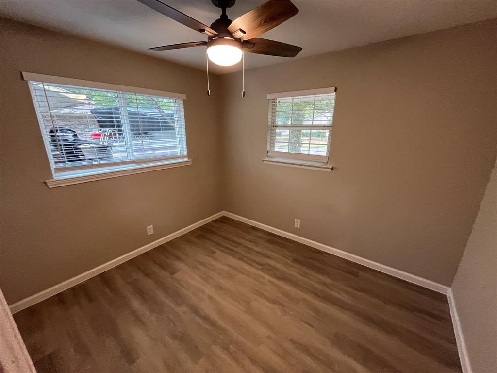 Wood-finish flooring throughout, complemented by a ceiling fan with integrated lighting