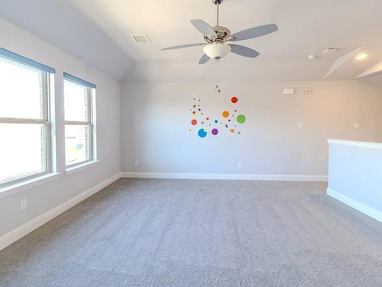 Vaulted ceiling with a ceiling fan, recessed lighting, and soft carpet flooring