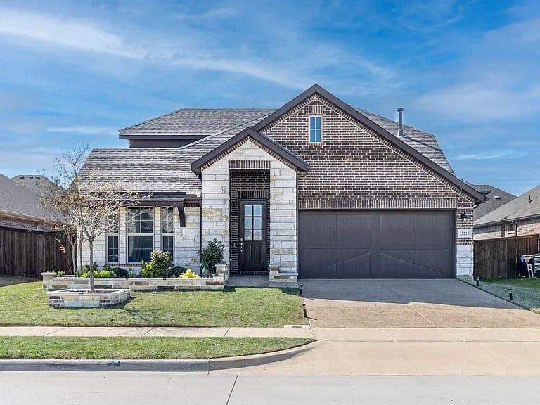Brick and stone facade with a dark gray garage door