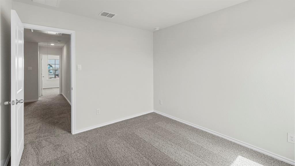 Room featuring neutral wall finishes and grey carpet flooring