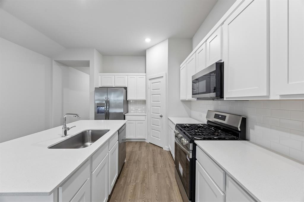 Kitchen in the Cedar home plan by Trophy Signature Homes – REPRESENTATIVE PHOTO