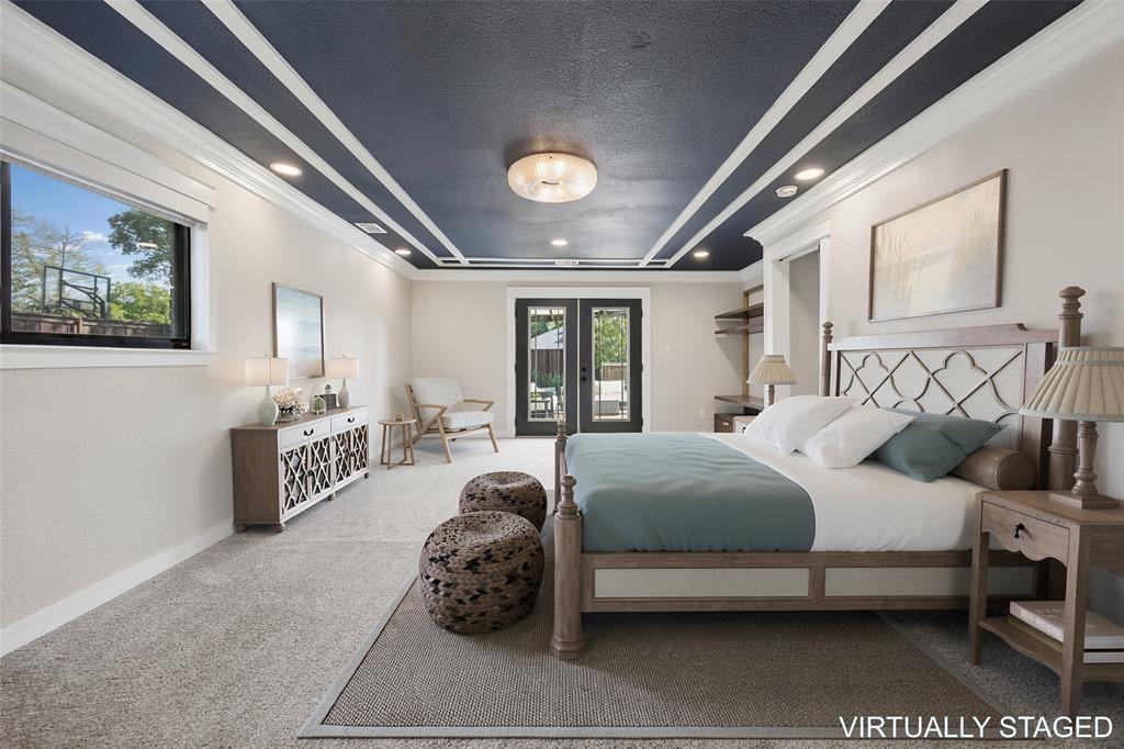 Spacious primary suite with detailed mill work, ensuite primary bathroom and custom closet system.  Easy access to backyard patio through french doors.