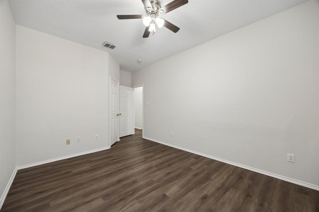 Plenty of Wall Space to Make It Your Own – This secondary bedroom offers a practical shape, good furniture placement options, and the same carpet-free flooring found throughout the home.