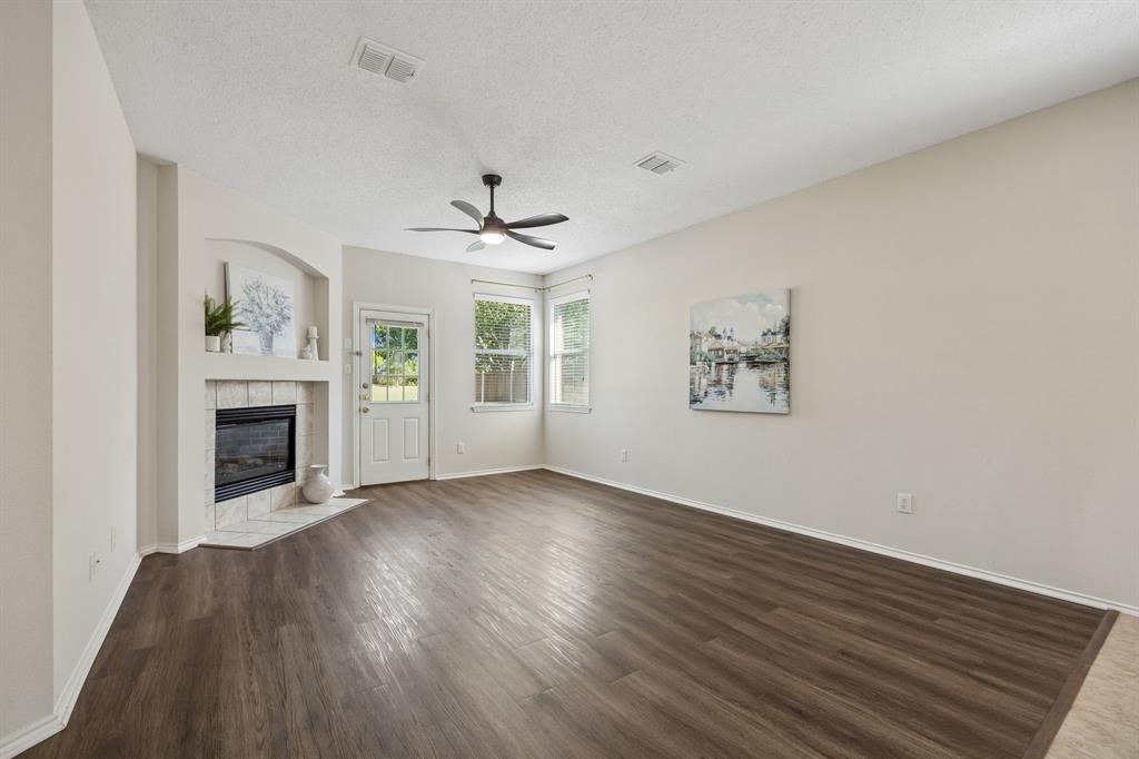 Gather Around the Fireplace – The gas fireplace creates a natural focal point in this generously sized family room, while windows near the backyard invite in light and a glimpse of the green surroundings beyond.