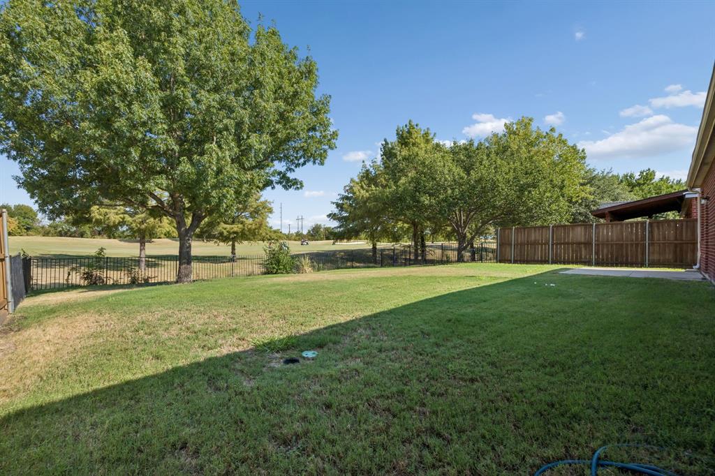 Your Own Front-Row Seat to the 14th Fairway – Step outside to a backyard that opens visually to the golf course, with a patio for grilling or relaxing and mature trees framing the fairway views.