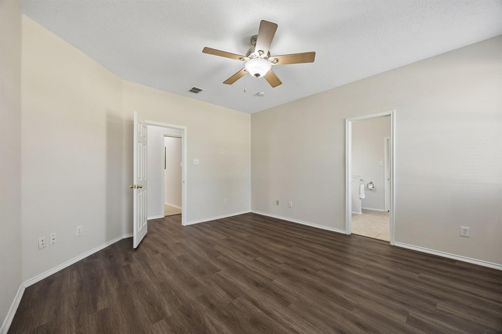 A Primary Suite with Room to Unwind – Generous dimensions give the primary bedroom plenty of flexibility for a full furniture arrangement, while LVP flooring continues the home’s carpet-free design and the ensuite bath is just steps away.