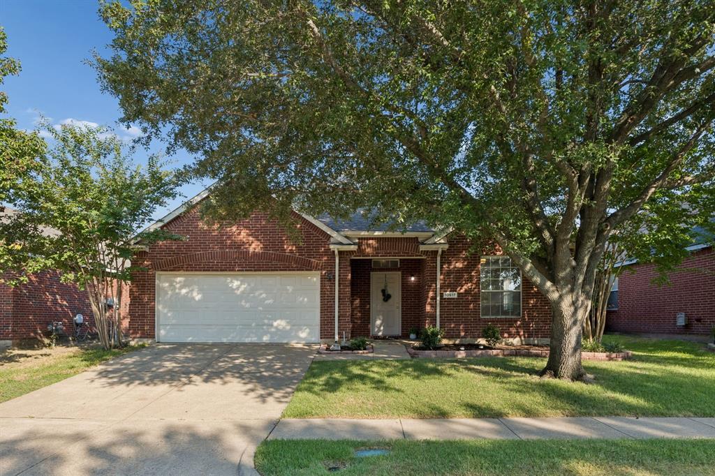 Classic Red Brick Curb Appeal – A welcoming single-story exterior pairs timeless red brick with mature shade trees, a covered entry, full gutters, and an attached garage for a polished first impression.